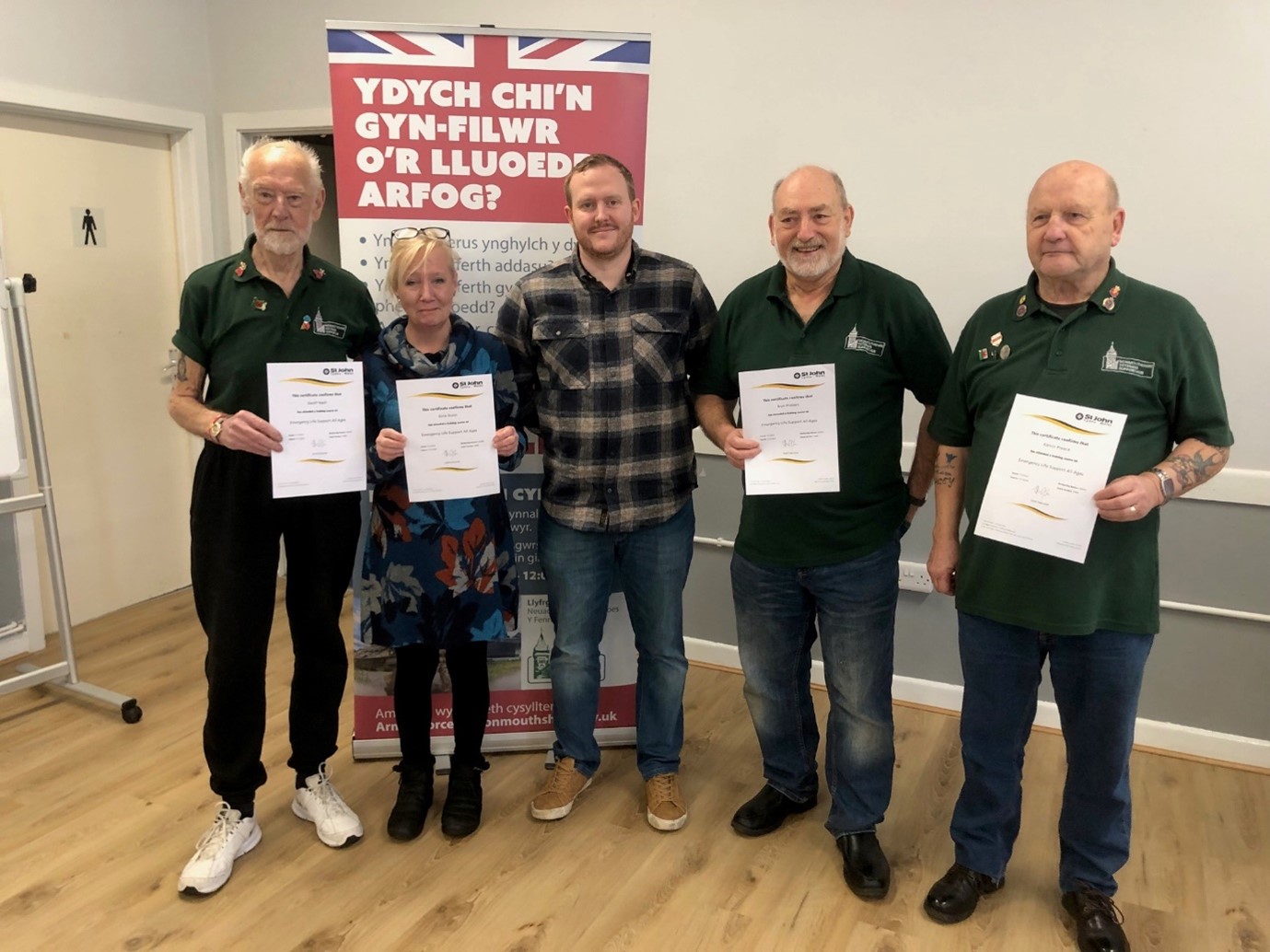 Five members of the Veterans group standing with their first aid certificates.